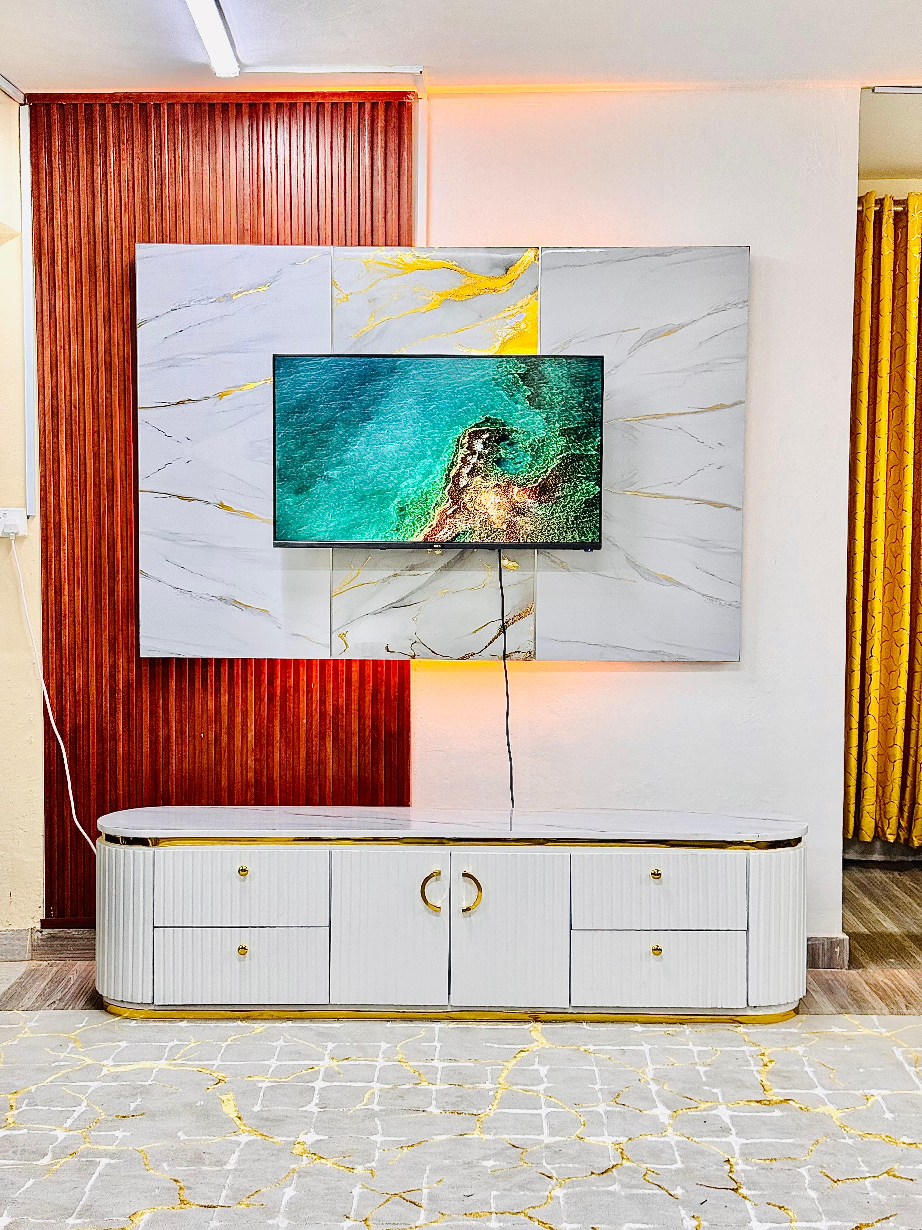A bright living room with a TV console and coffee table